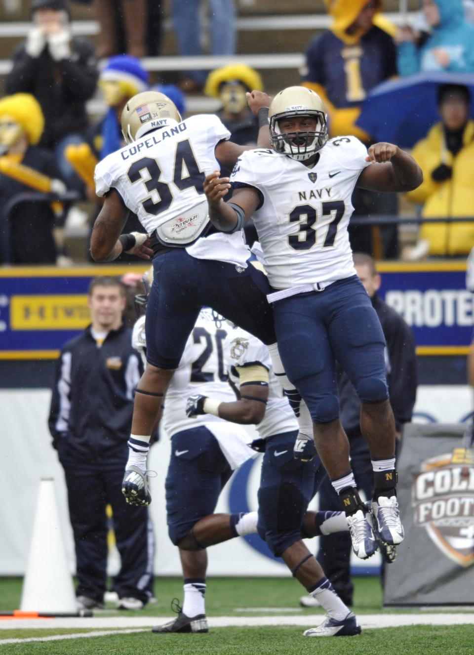 Navy fullback Chris Swain (37) celebrates his 2-yard touchdown run with fullback Noah Copeland during the first quarter of an NCAA college football game against Toledo in Toledo, Ohio, Saturday, Oct. 19, 2013. (AP Photo/David Richard)