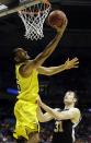 Michigan forward Jon Horford (15) goes to the basket over Wofford forward C.J. Neumann (31) during the first half of a second round NCAA college basketball tournament game Thursday, March 20, 2014, in Milwaukee. (AP Photo/Morry Gash)