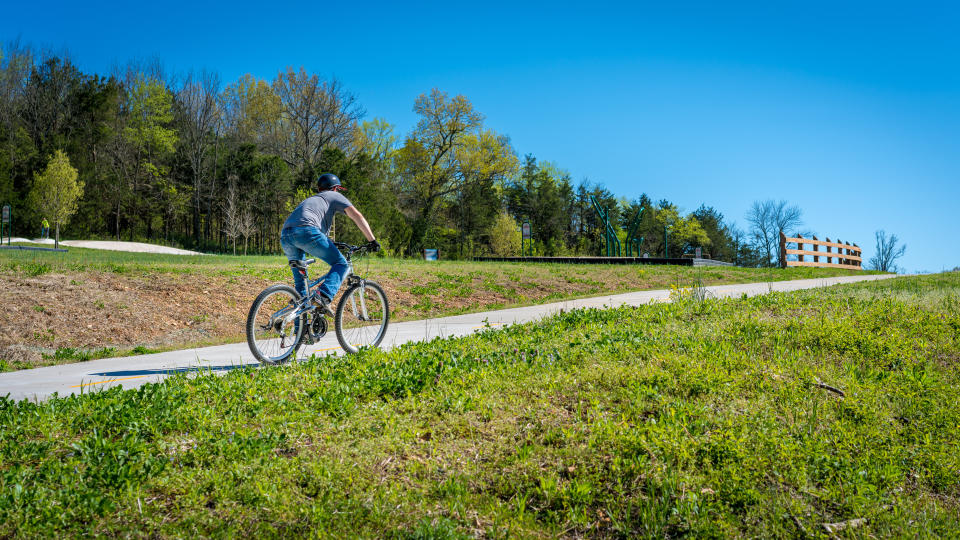 Young man biking on bike trail in Bella Vista, Northwest Arkansas - Image.