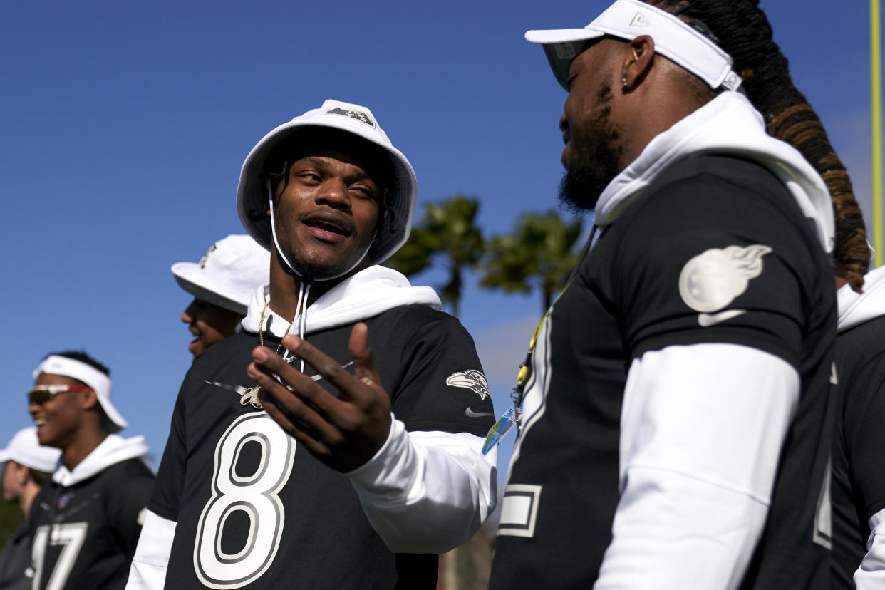 Football fans will get to see Lamar Jackson and Derrick Henry in the same backfield this season. The Ravens' hopes at a deep playoff run may depend on it. (Photo by Cooper Neill/Getty Images)