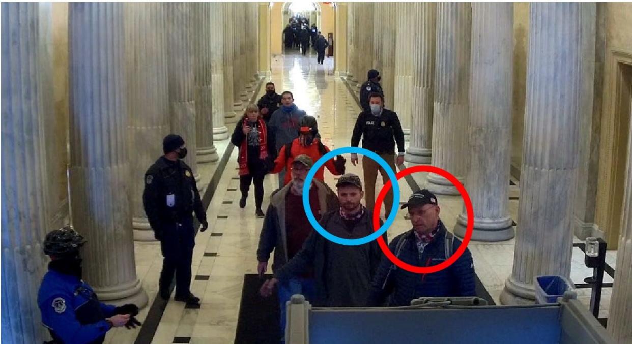 Daryl Johnson, right, circled in red, and his son Daniel Johnson as seen in a surveillance video during the Jan. 6, 2021, attack on the U.S. Capitol.