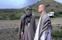 In this file image taken from video obtained from Voice Of Jihad Website, which has been authenticated based on its contents and other AP reporting, Sgt. Bowe Bergdahl, right, stands with a Taliban fighter in eastern Afghanistan. The Taliban said Friday, June 6, 2014, that Bergdahl was treated well during the five years they held him captive and was even allowed to play soccer with the men holding him. (AP Photo/Voice Of Jihad Website via AP video)