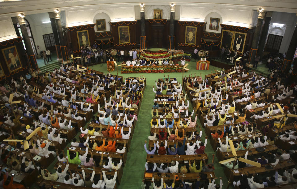 Newly elected lawmakers from India's ruling alliance led by the Hindu nationalist Bharatiya Janata Party raise their hands in support of Narendra Modi being elected their leader in New Delhi, India, Saturday, May 25, 2019. BJP president Amit Shah announced Modi's name as the leader of the National Democratic Alliance in a meeting of the lawmakers in the Central Hall of Parliament in New Delhi, paving the way for Modi's second five-year term as prime minister after a thunderous victory in national elections. (AP Photo/Manish Swarup)