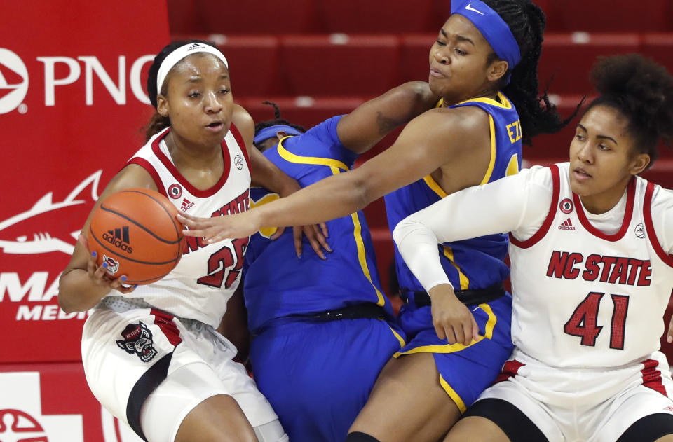 North Carolina State's Kayla Jones (25) pulls the rebound from Pittsburgh's Cynthia Ezeja (14) during the first half of an NCAA college basketball game, Thursday, Feb. 25, 2021 in Raleigh, N.C. (Ethan Hyman/The News & Observer via AP, Pool)