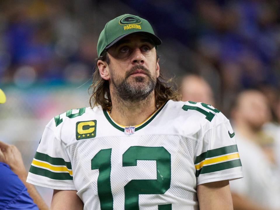 Aaron Rodgers looks up from the sideline during a game in 2022.