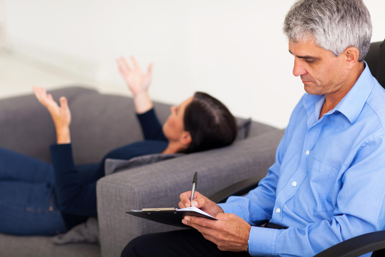 middle aged male therapist consulting female patient in office