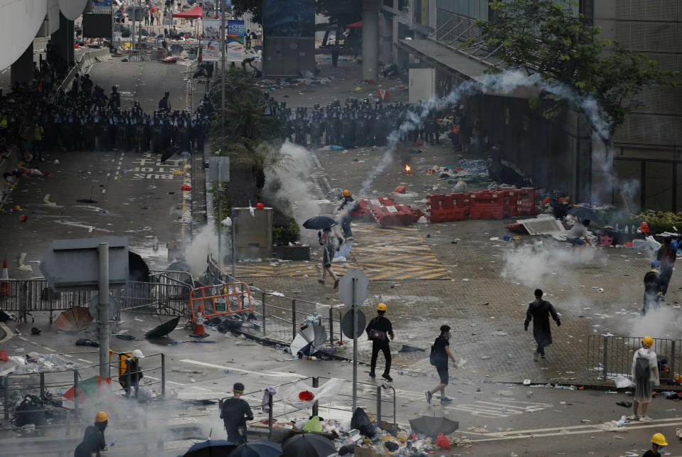 Riot police fire tear gas towards protesters outside the Legislative Council in Hong Kong, Wednesday, June 12, 2019. Hong Kong police have used tear gas and high-pressure hoses against thousands of protesters opposing a highly controversial extradition bill outside government headquarters. (AP Photo/Vincent Yu)