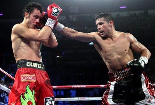 Sergio Martinez (R) throws a right at Julio Cesar Chavez Jr. during their WBC middleweight title fight on September 15. Martinez survived a late knockdown to reclaim the belt when he defeated Chavez Jr. by a unanimous points decision