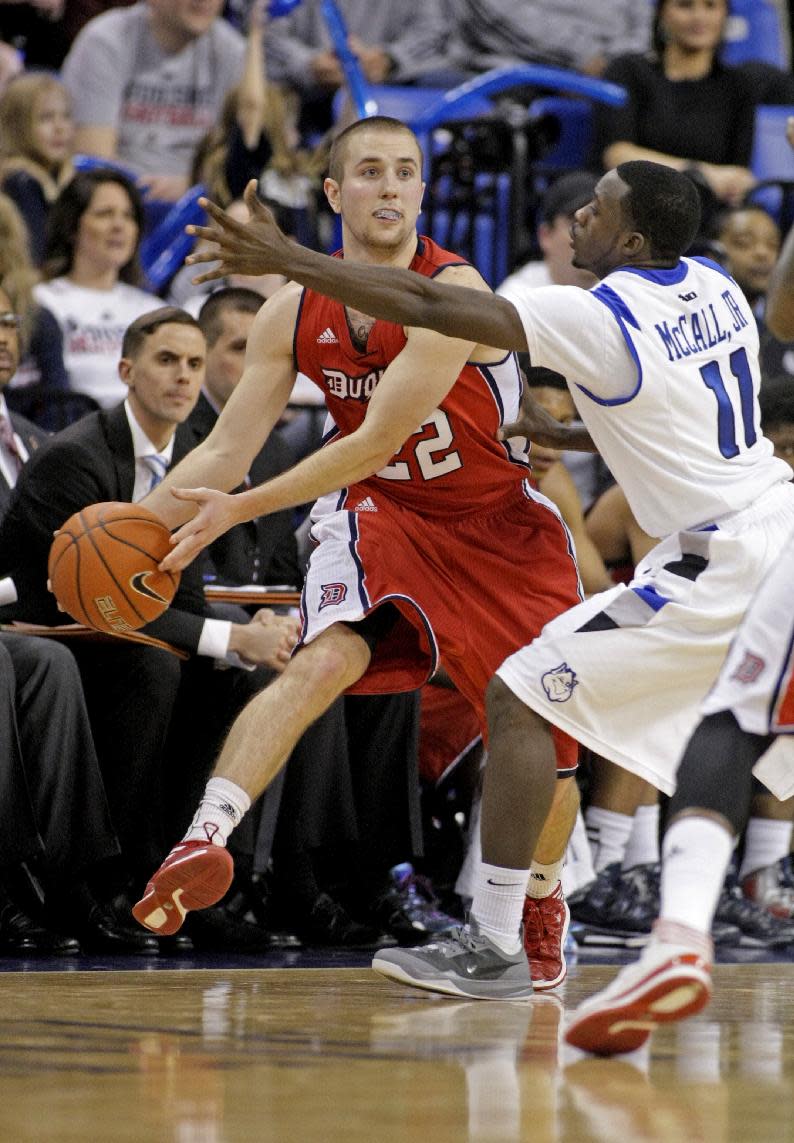 Duquesne's Micah Mason (22) passes around Saint Louis' Mike McCall Jr. (11) during the second half of an NCAA college basketball game, Thursday, Feb. 27, 2014 in St. Louis. Mason led all scorers with 22 points as Duquesne defeated Saint Louis 71-64. (AP Photo/Tom Gannam)