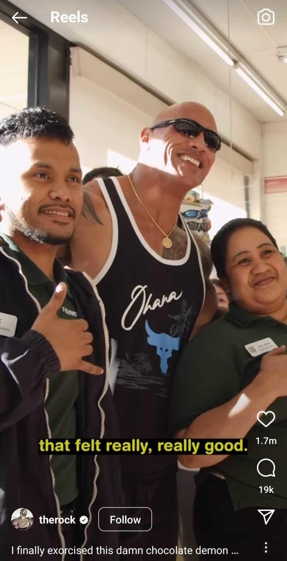 Dwayne Johnson and the two 7-Eleven associates smiling for a photo