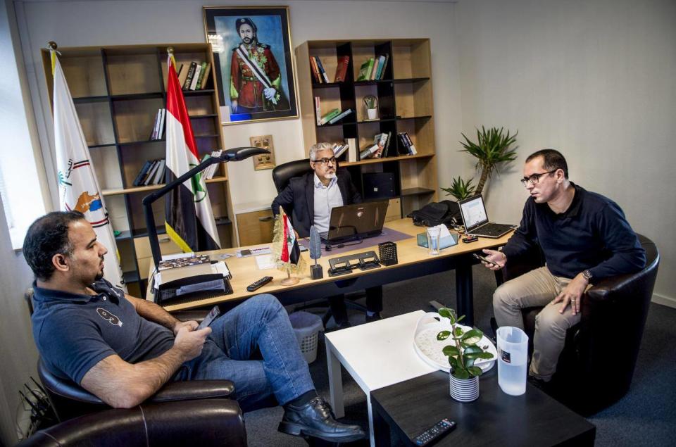 Habib Jabor, centre, and other members from the ASMLA group meet in an office in Ringsted (EPA-EFE)