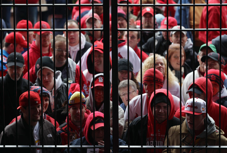 ST LOUIS, MO - OCTOBER 19: Fans stand in the rain as the they wait to enter Busch Stadium prior to Game One of the MLB World Series between the Texas Rangers and St Louis Cardinals on October 19, 2011 in St Louis, Missouri. (Photo by Doug Pensinger/Getty Images)