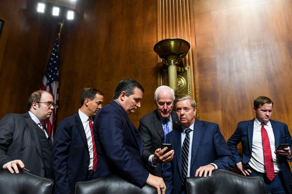 (Third, fourth and fifth from left) Sen. Ted Cruz (R-Texas), Sen. John Cornyn (R-Texas) and Sen. Lindsey Graham (R-S.C.) with staffers at the hearing.