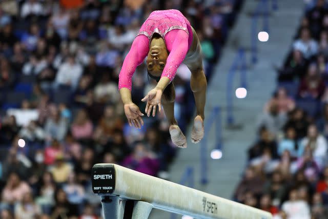 <p>Tim Nwachukwu/Getty </p> Simone Biles performs on the balance beam during the 2024 Core Hydration Classic on May 18, 2024