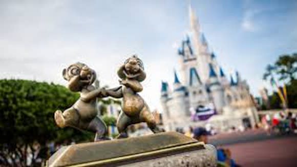 A statue of Chip and Dale in front of the Tokyo Disney version of Cinderella's castle.