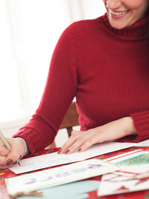 woman writing holiday cards