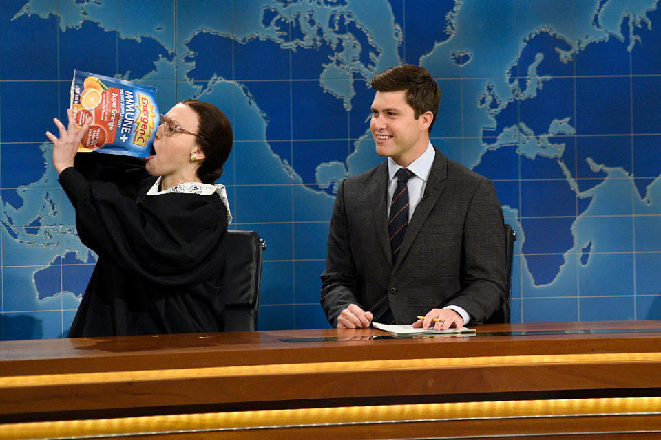 Kate McKinnon as Supreme Court Justice Ruth Bader Ginsburg ingests a very large packet of Emergen-C on "Saturday Night Live" as Colin Jost watches