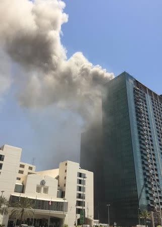 Smoke rises after a fire broke out in a building at Al Maryah Island in Abu Dhabi, UAE, August 30, 2016. REUTERS/Stanley Carvalho