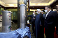 FILE - In this April 10, 2021 file photo released by the official website of the office of the Iranian Presidency, President Hassan Rouhani, second right, listens to head of the Atomic Energy Organization of Iran Ali Akbar Salehi while visiting an exhibition of Iran's new nuclear achievements in Tehran, Iran. Negotiations aimed at bringing the United States back into the landmark nuclear deal with Iran are resuming on Thursday, April 15. At issue is how to revive a 2015 deal between Iran and world powers that was intended to set limits on Tehran’s nuclear program in order to make it impossible for it to build a nuclear weapon. (Iranian Presidency Office via AP, File)