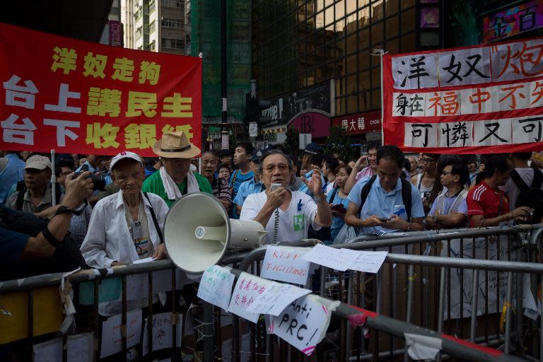 A group of elderly men playing patriotic Communist marching songs shout at pro-democracy protesters in Hong Kong's Causeway Bay district, on October 5, 2014