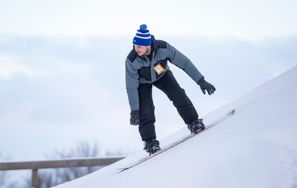Matt Konkler snowboards down a hill on Friday, Jan. 27, 2023, at Snow Park at Alpine Hills in Rockford.