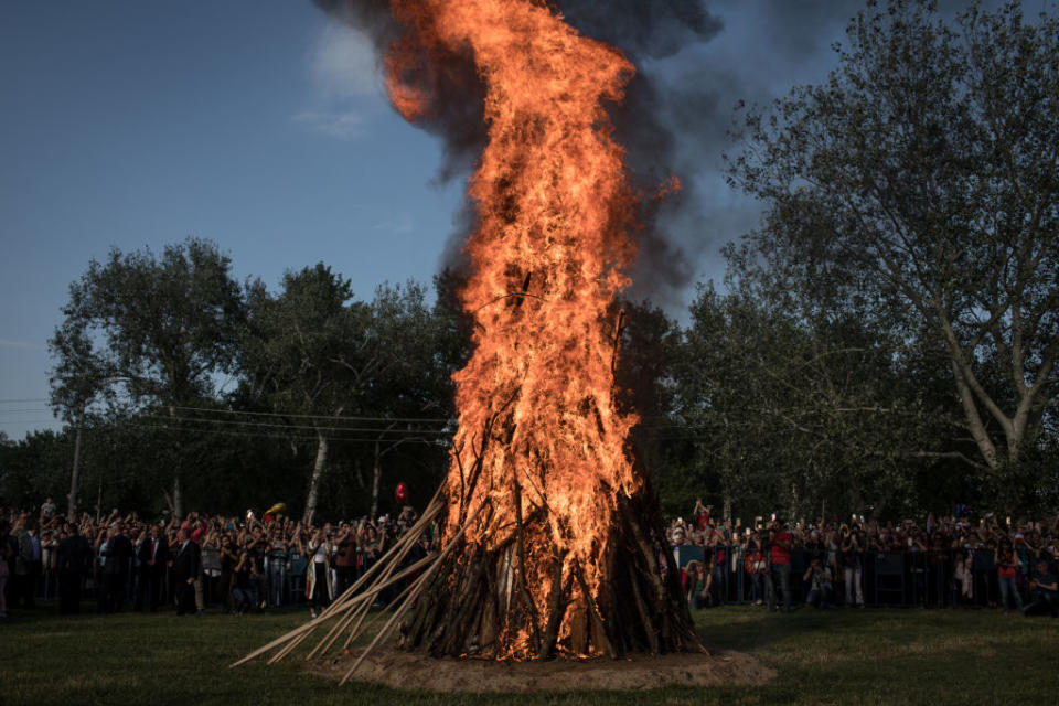 <p>People watch on as a large bonfire is lit during the Kakava Festival on May 5, 2018 in Edirne, Turkey. The annual Kakava spring festival celebrates the coming of spring amongst the Roma community. (Photo from Chris McGrath/Getty Images) </p>