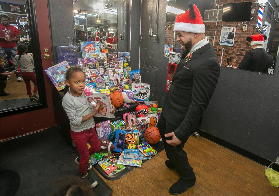 Draque Murff, owner of Draque’s Barbershop, 106 W. 39th St., and staff donated food, haircuts and over 100 toys to Kansas City kids at his Holiday Harvest Toy Drive.