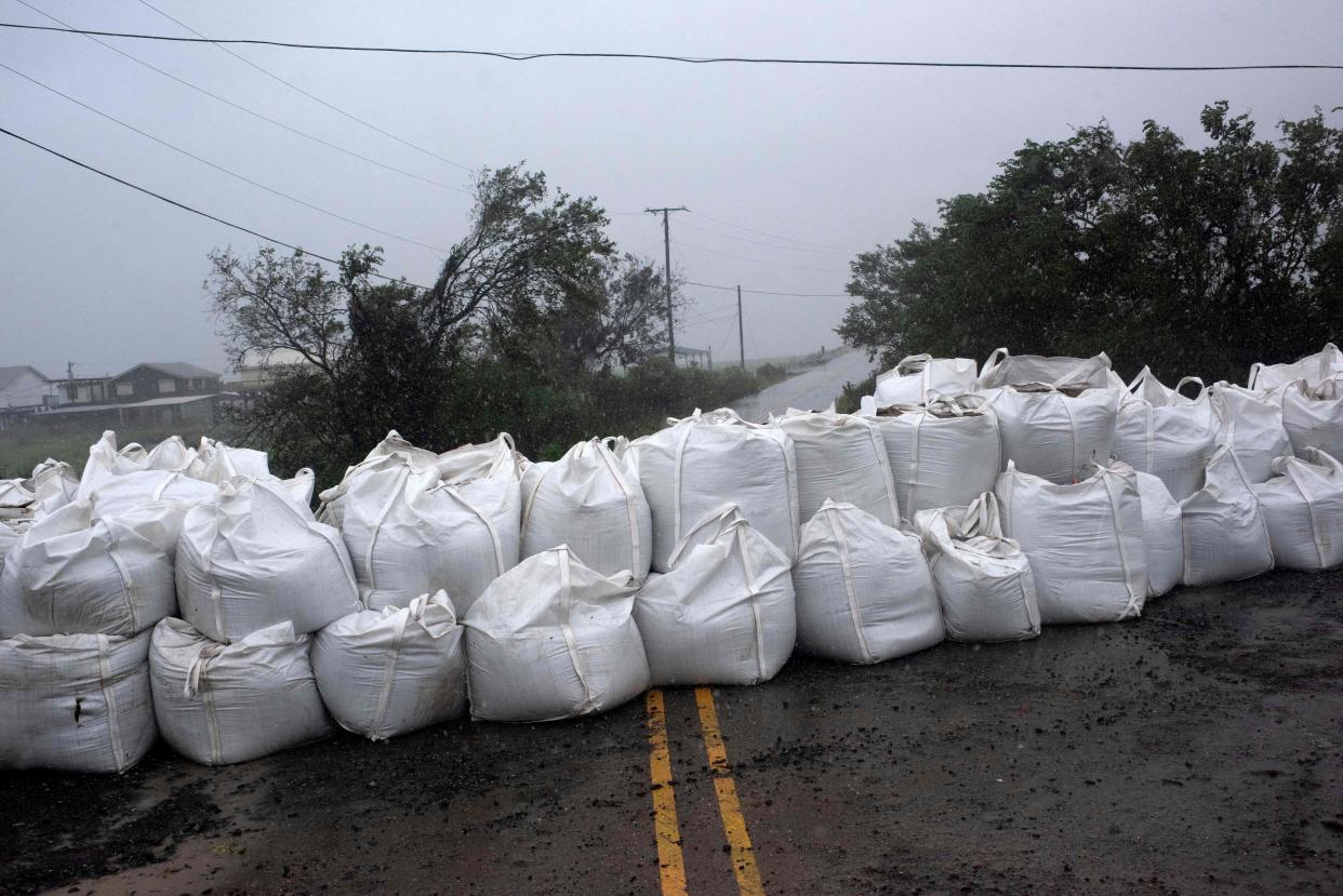 Rain comes down on a wall of sandbags in Montegut, Louisiana before Hurricane Ida lands on Aug. 29, 2021.