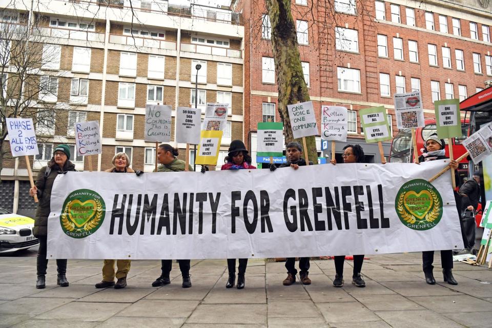 Protesters outside the Grenfell Tower public inquiry in London (PA)