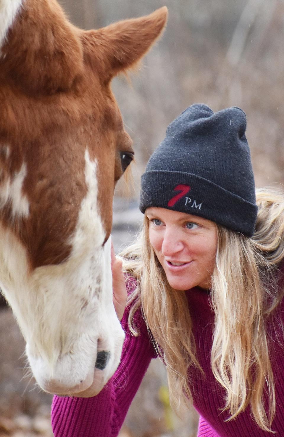 Nicole Wood, an EAGALA-certified equine specialist, works with Tecumseh in the Medicine Horse program.