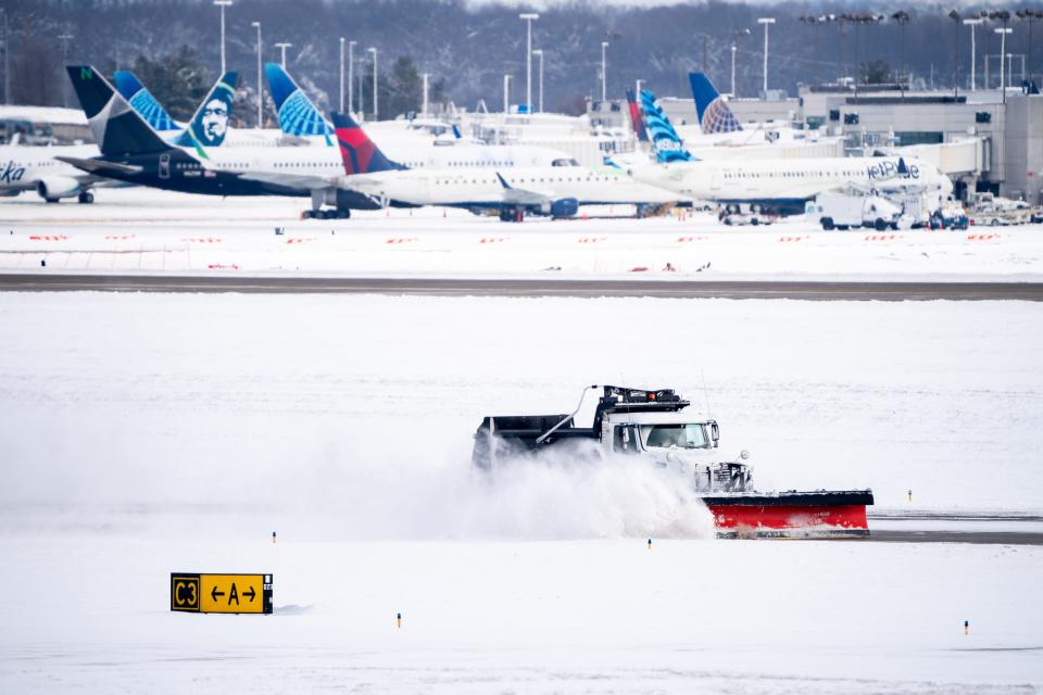 Crews works on clearing snow at Nashville International Airport in Nashville, Tenn., Tuesday, Jan. 16, 2024.