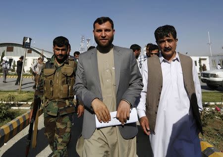 The head of Afghanistan's Independent Election Commission (IEC) secretariat, Zia-ul-Haq Amarkhil (C) leaves after a news conference in Kabul June 23, 2014. Amarkhil, a senior official of Afghanistan's IEC, stepped down on Monday amid allegations that he organised a fraudulent run-off vote, charges he denied. REUTERS/Mohammad Ismail