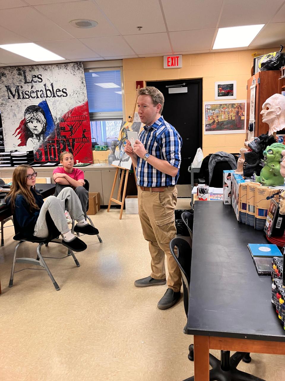 Matt Feck explaining to the students how to use laser engraver. The students are Madelyn Weiler, 14, (left) and Addie Weber.