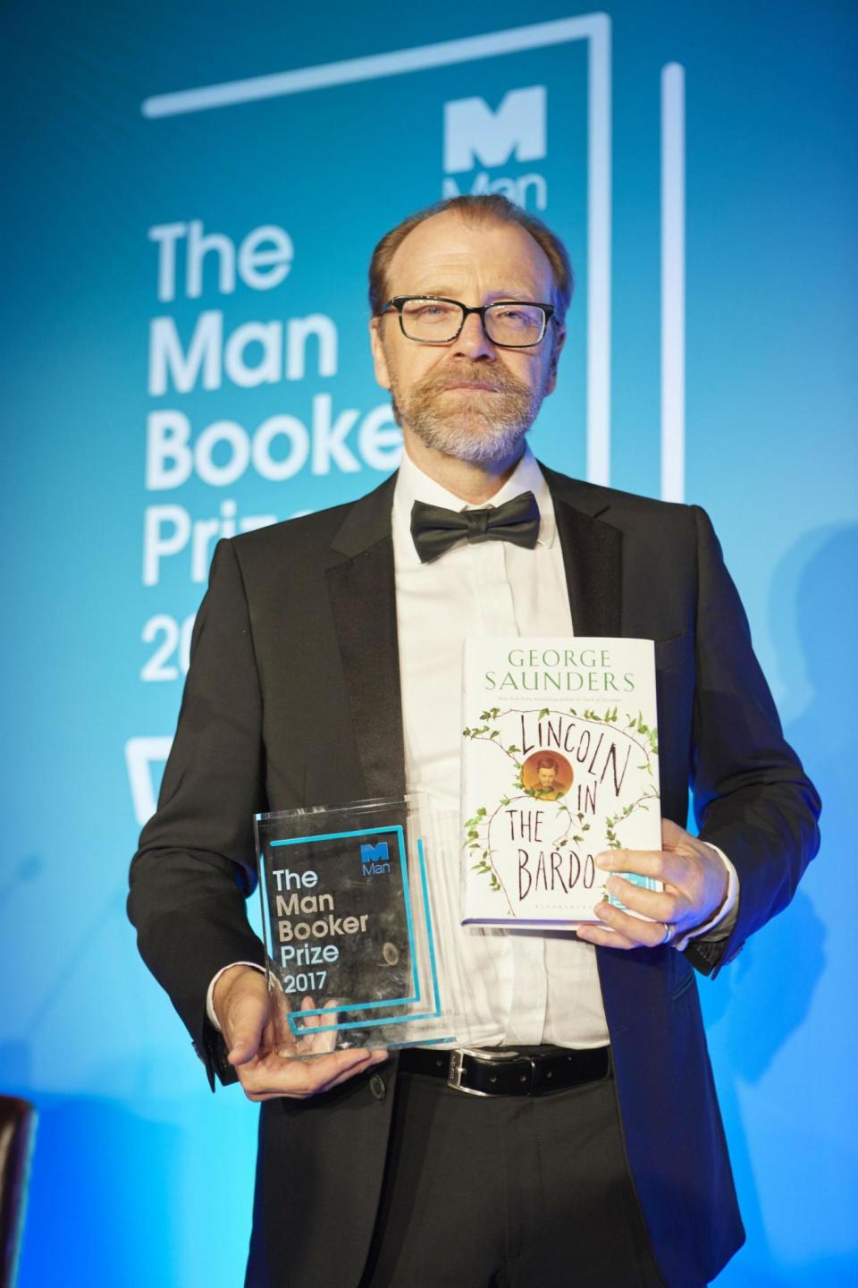 The American writer poses with his book, ‘Lincoln in the Bardo’, after winning the 2017 Man Booker Prize