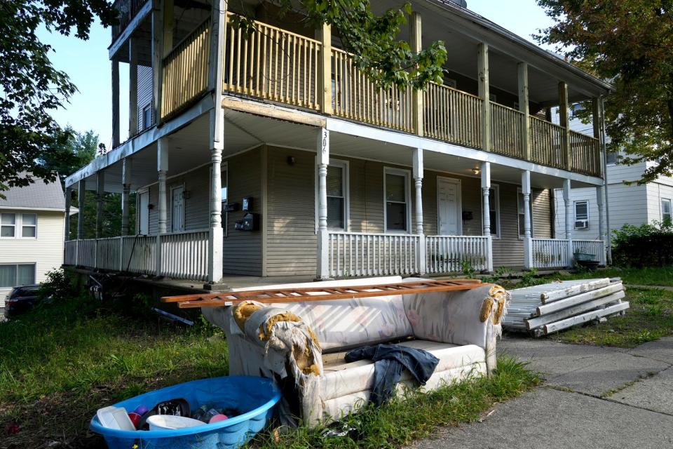 An old couch and other trash that tenants said had been sitting out in front of the apartment house at 306 Washington St. in West Warwick for almost four months last September.
