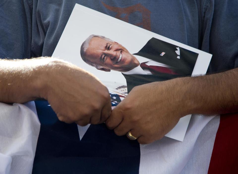 A supporter holds a photograph of Vice President Joe Biden at the Metro Detroit AFL-CIO Labor Day Rally, Monday, Sept. 3, 2012, in Detroit. (AP Photo/Carolyn Kaster)