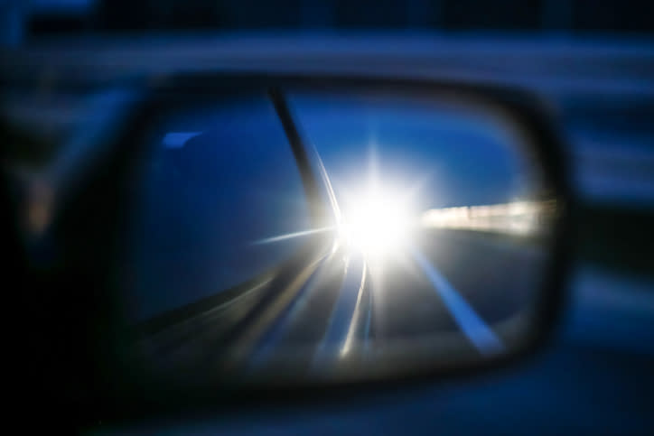 A headlight in someone's side mirror