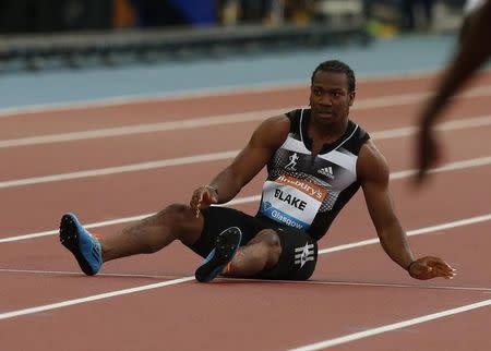 Yohan Blake of Jamaica falls injured in the men's 100m during the IAAF Diamond League athletics meeting at Hampden Park in Glasgow July 11, 2014. REUTERS/Phil Noble