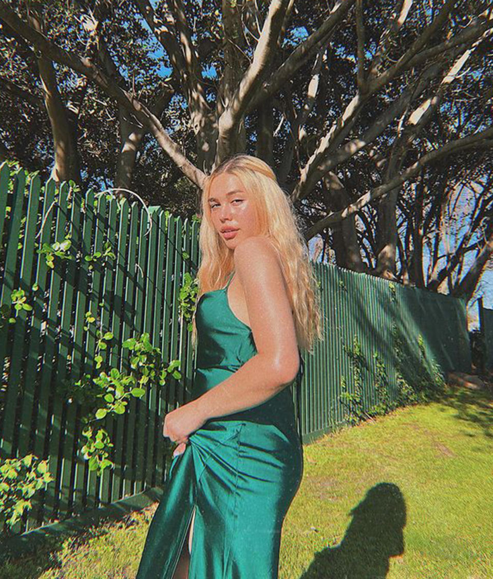 TikTok star AJ Clementine wearing a green slip dress. Photo: TikTok/ajclementine.