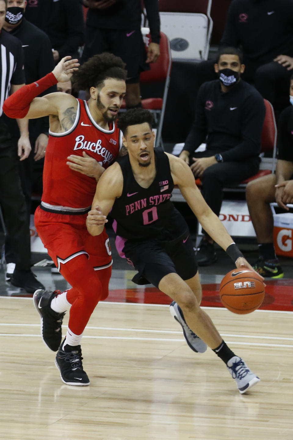 Penn State's Myreon Jones, right, tries to dribble past Ohio State's Duane Washington during the second half of an NCAA college basketball game Wednesday, Jan. 27, 2021, in Columbus, Ohio. Ohio State beat Penn State 83-79. (AP Photo/Jay LaPrete)