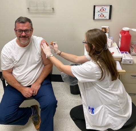 American Pharmacists Association CEO and Executive Vice President Michael Hogue getting vaccinated earlier this month at a Walgreens in Kansas City, where he traveled to tour pharmacies and meet with CVS employees who had organized a walkout in late September.