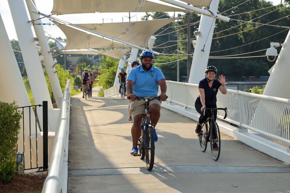 Cyclists on the pedestrian bridge near Cascades Park. Spending time outdoors each day lowers the stress hormone cortisol, which means you enjoy a more positive outlook in general.