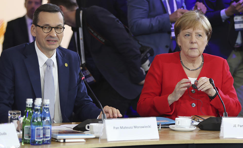 German Chancellor Angela Merkel,right, and Poland's Prime Minister Mateusz Morawiecki listening to a speech by Poland's President Andrzej Duda during a summit meeting that aims to reassure Western Balkan states that their aspirations to join the European Union have backing among EU leaders, in Poznan, Poland, Friday, July 5, 2019.(AP Photo/Czarek Sokolowski)