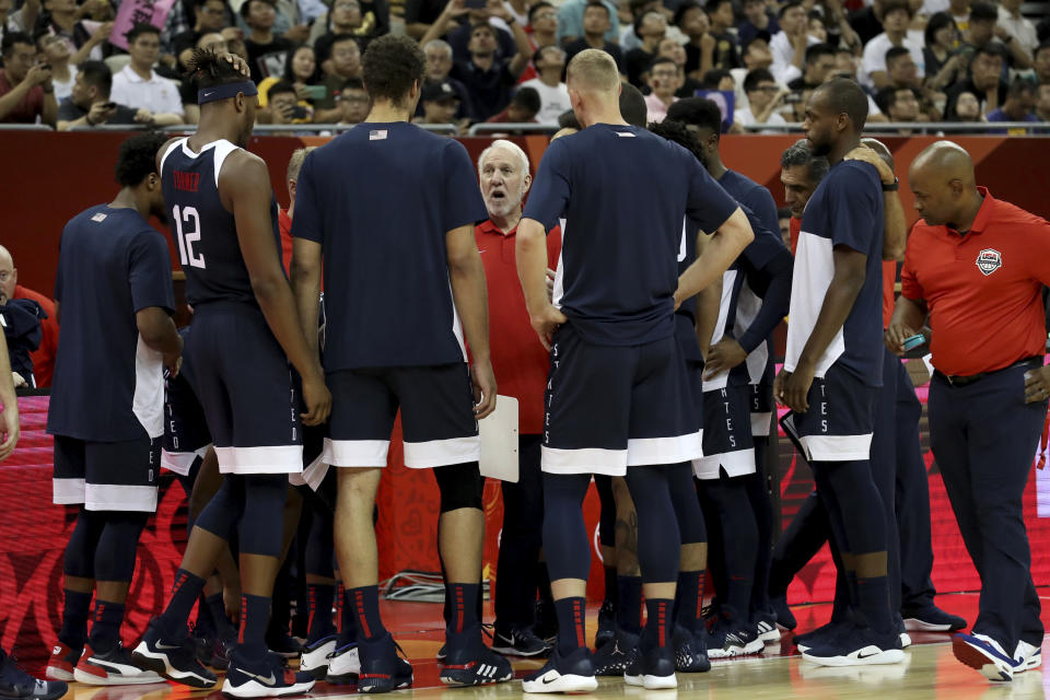 FILE - In this Sept. 1, 2019, file photo, U.S. coach Gregg Popovich talks to players before a Group E match against the Czech Republic in the FIBA basketball World Cup in Shanghai. Kevin Durant and coach Popovich will lead the U.S. team into the Tokyo Olympics as the Americans try to secure a fourth consecutive gold medal. (AP Photo/Ng Han Guan, File)