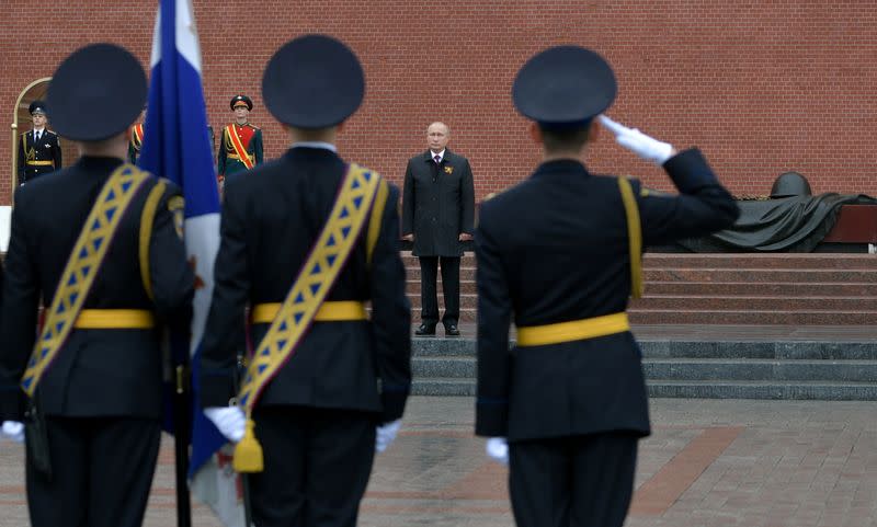 Russian President Vladimir Putin takes part in a flower-laying ceremony at the Tomb of the Unknown Soldier on Victory Day in central Moscow