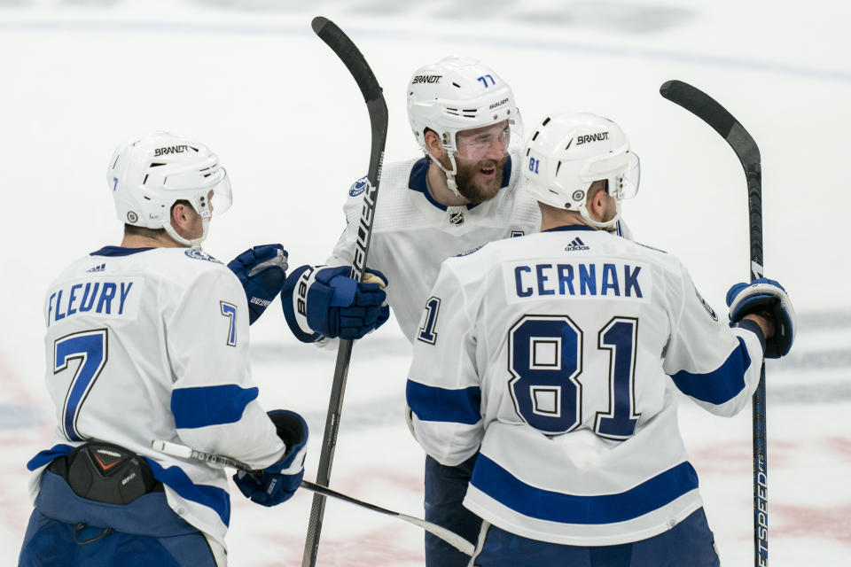 Tampa Bay Lightning defenseman Victor Hedman (77) celebrates with Lightning defenseman Haydn Fleury (7) and Lightning defenseman Erik Cernak (81) after scoring the game-winning point against the Washington Capitals during a shootout in an NHL hockey game, Saturday, Dec. 23, 2023, in Washington. (AP Photo/Stephanie Scarbrough)