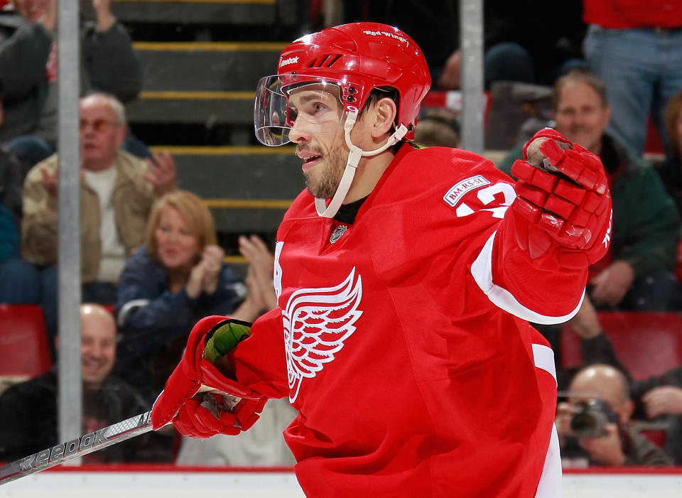 DETROIT, MI - OCTOBER 28: Pavel Datsyuk #13 of the Detroit Red Wings celebrates a second-period assist on a goal by teammate Tomas Holmstrom #96 while playing the San Jose Sharks at Joe Louis Arena on October 28, 2011 in Detroit, Michigan. San Jose won the game 4-2. (Photo by Gregory Shamus/Getty Images)