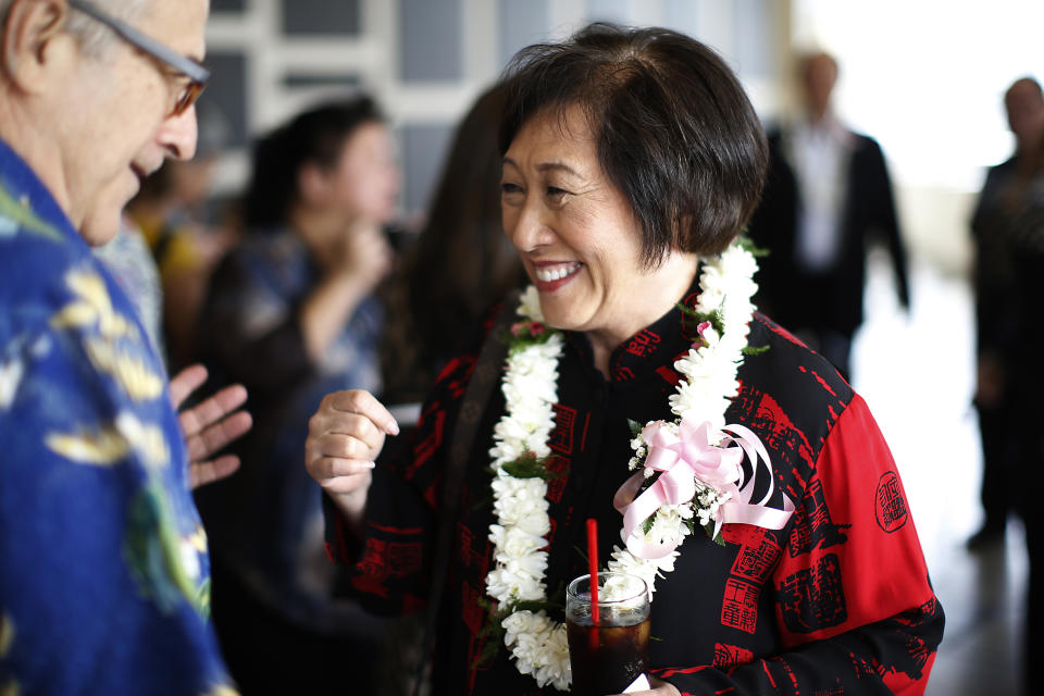 In this April 28, 2018 photo, U.S. Rep. Colleen Hanabusa, D-Hawaii, who is giving up her seat in Congress to run for Hawaii governor, talks with a guest at an event in Honolulu. Hawaii Gov. David Ige faces a stiff challenge from Hanabusa in the Democratic primary on Saturday, Aug. 11, 2018. (AP Photo/Marco Garcia, File)