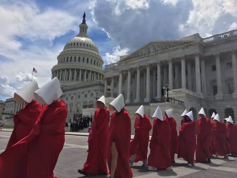 “Handmaids” staged a silent protest outside the U.S. Capitol building, and it was an eerie (and beautiful) sight