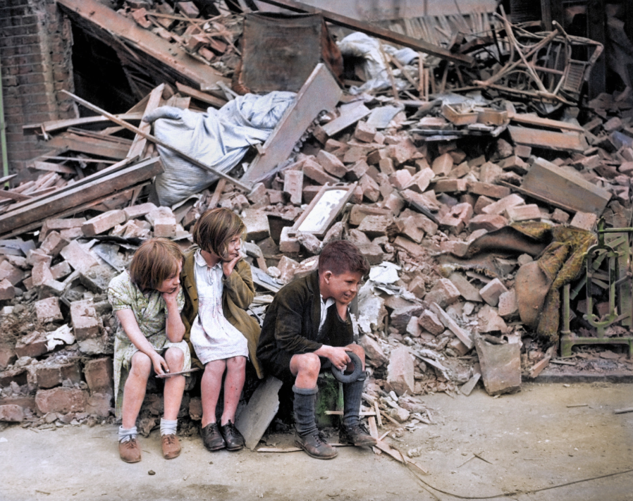 <p>Three children sit by what remains of their home following an overnight attack in East London. (MediaDrumWorld) </p>